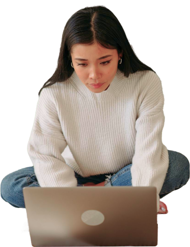 A young woman looking fascinated at her computer screen.